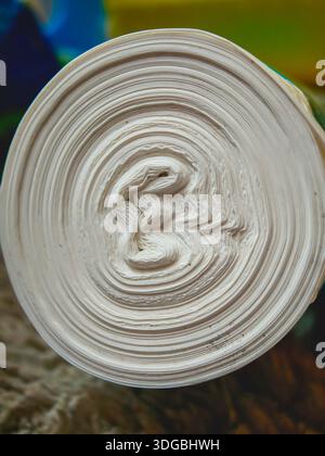 Rolled white paper showing numerous layers and concentric circles forming a unique abstract texture with a dynamic spiral pattern at its core, creatin Stock Photo