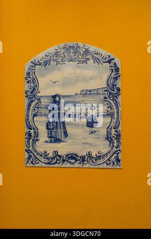 Blue and white mural made of tiles on an orange wall.  Beautifully made. Stock Photo