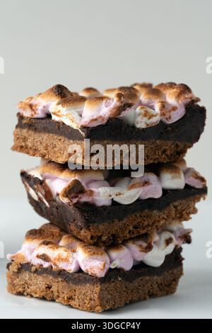Three chocolate bars with marshmallows on top of each other. The bars are stacked on top of each other, creating a tower of deliciousness Stock Photo