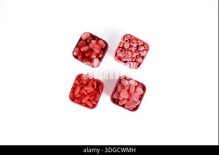 Valentine’s red and pink candy in red square containers with leaning lids Stock Photo