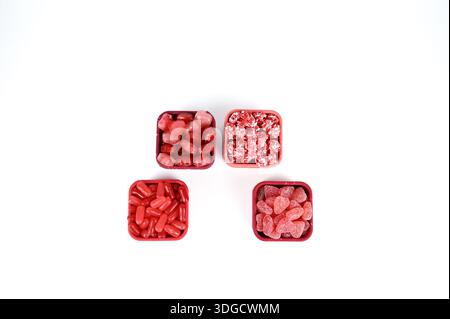 Valentine’s red and pink candy in red square containers with leaning lids Stock Photo