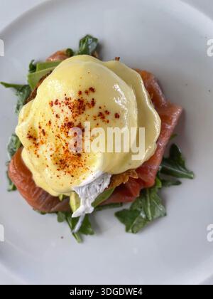 overhead of eggs benedict on white plate Stock Photo