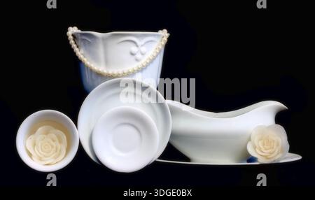 White dishes on black background Stock Photo