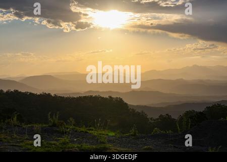 Vibrant sunset viewed from O'Reilly's Rainforest Retreat, with orange light illuminating clouds during a guided sunset tour. Stock Photo