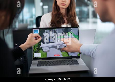 Diverse Team Of Engineers Using CAD Software For Home Construction. Stock Photo