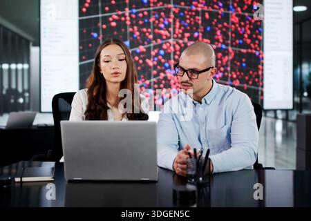 Diverse Group Of Software Engineers Collaborating In Cyber Security Center. Stock Photo
