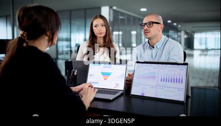 Analyzing Data With Diverse Business Team In Technology Meeting Room. Stock Photo