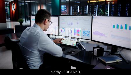 Latino Financial Analyst Analyzing Market Trends On Virtual Dashboard Screen. Stock Photo