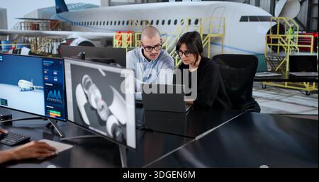 Diverse Group Of Aircraft Industry Engineers Performing Technical Maintenance. Stock Photo