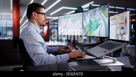 Young Hispanic Male Using CAD Software To Design Commercial Building Interior. Stock Photo