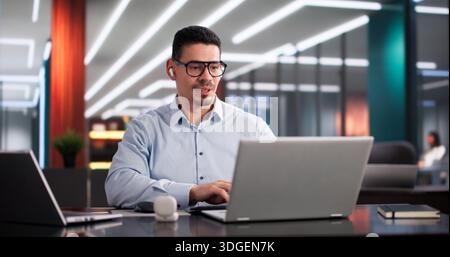 Hispanic Professional Attending Virtual Business Conference On Laptop Computer Screen Stock Photo