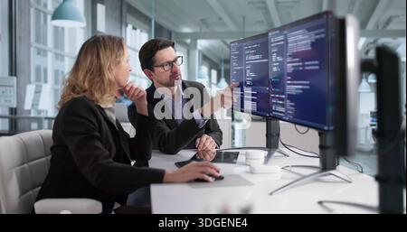 Male And Female Programmers Developing Cybersecurity Software In Office Stock Photo