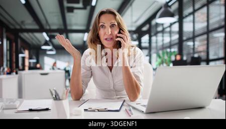 Upset Customer Service Woman On Phone At Tech Support Center. Stock Photo