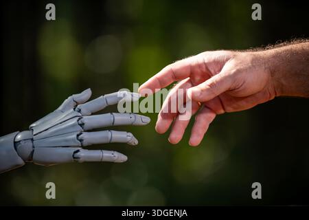Robot and human hands in futuristic concept. Robotic hands with human engineering. Robot hands on automation machine. Human hands with robot Stock Photo