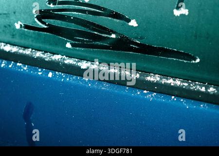 Frozen car window showing melting ice and seasonal change Stock Photo