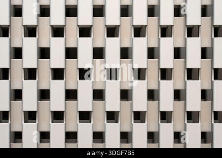Modern architectural facade with a repetitive geometric pattern of white rectangular blocks. Abstract minimalist wall design with shadows and light Stock Photo