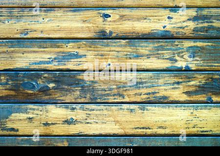 Weathered wooden background with horizontal planks. Shabby chic texture of aged timber with peeling blue paint and visible natural grain. Stock Photo