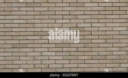 Beige brick wall with neat rows of rectangular blocks in different shades of brown and gray as an empty textured street building design background Stock Photo