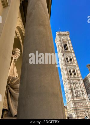 Giotto bell's tower in Florence with a statue in the foreground Stock Photo