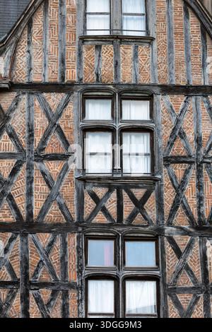 Close up view of historic half-timbered house facade with wooden beams and red brick herringbone pattern masonry in Tours France creating a beautiful Stock Photo