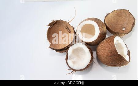 Coconut halves and empty shells on white background with copy space for design Stock Photo