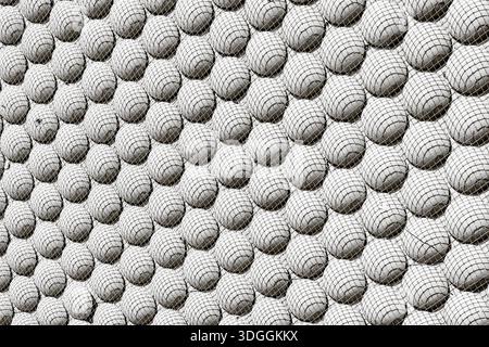 A black and white abstract background with a repeating geometric pattern of spheres covered in a grid texture. A modern, futuristic, and rhythmic arch Stock Photo