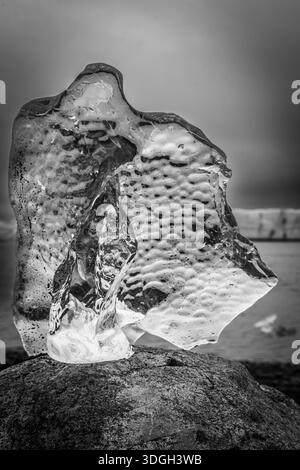 I picked up a very shapely piece of transparent ice and placed it on some granite to take some images. You can imagine my hands nearly freezing off. Stock Photo
