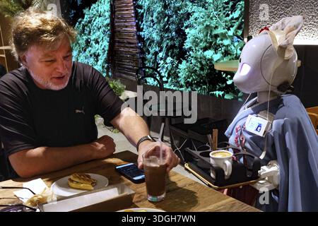Interaction between humans and robots at Avatar Robot Cafe in Tokyo, Tokyo, Japan Stock Photo