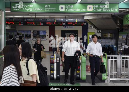 Entrance of a busy train station with commuters in Tokyo, Tokyo, Japan Stock Photo