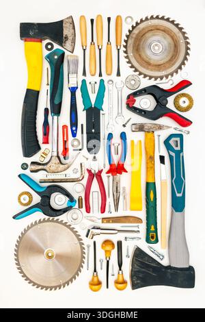 Flat lay of new and used hand tools on white background. Large collection of various tools and bits arranged on white. Stock Photo