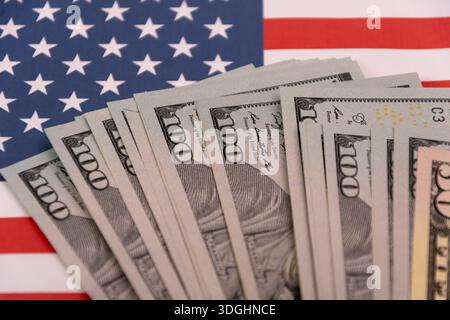 Close up of US dollar bills on the American flag. Stock Photo