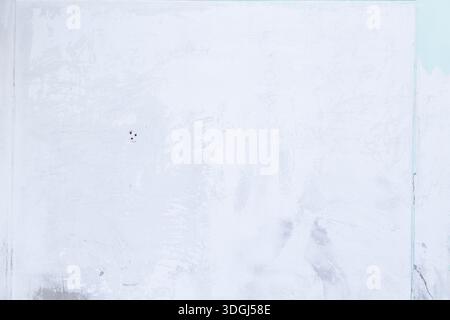 Front view of a weathered white wall with scratches and smudges. Abstract high resolution full frame textured background, copy space. Stock Photo