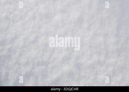 Soft white snow texture with subtle natural grain and delicate winter surface, minimal abstract background suitable for seasonal design, holiday theme Stock Photo