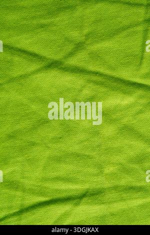 Closeup view of bright green wrinkled cotton fabric background Stock Photo