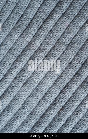 Closeup of industrially knitted polyester and wool blend fabric of light gray color background Stock Photo