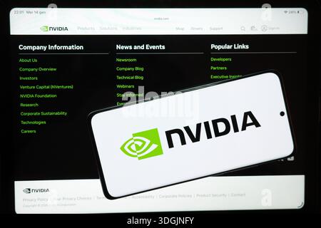 An illustration shows the Nvidia logo displayed on a smartphone alongside the company’s official website shown on a screen, in Palermo, Italy, on January 14, 2026, following reports that China’s customs agents were told Nvidia’s H200 artificial intelligence chips are not permitted (Photo by Cristian Bonaviri/Sipa USA) Stock Photo