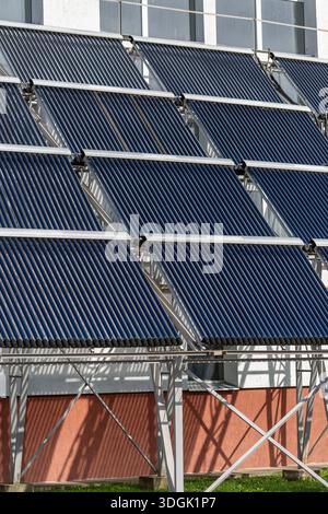 A solar thermal panel, evacuated tube, OPC 15, mounted on the wall of a ...