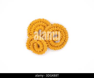 Crunchy Murukku or Chakli savory snacks isolated on a white background, highlighting spiral texture and spices. Stock Photo