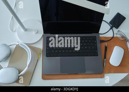 Workstation with notebook computer, mouse, headphones, and external hard drive for productivity Stock Photo