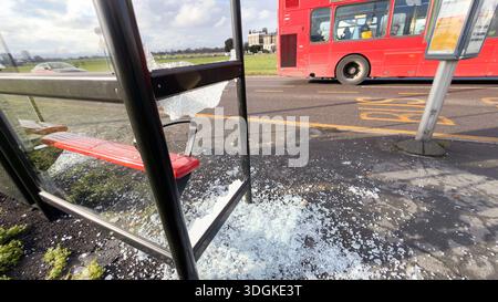 LONDON, UK -17th January, 2026: A bus stop at Blackheath Park stands as a hollow metal frame after its glass panels were completely shattered by vandals. Pedestrians and shoppers are seen navigating the shards of tempered glass covering the pavement before the site was cleared and cordoned off with red and white hazard tape. Images include a London double-decker bus departing the damaged stop, highlighting the ongoing disruption to public transport and local residents in South East London. Credit: Xiu Bao/17�Թ����� Live News Stock Photo