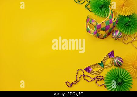 Mardi gras carnival masks beads yellow background with copy space Stock Photo