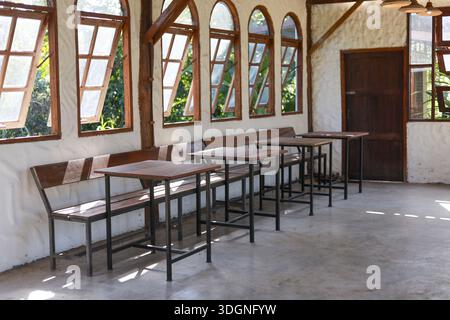 Empty rustic room featuring classic arched window design with bright sunlight reflecting concrete floor creating peaceful welcoming atmosphere perfect Stock Photo