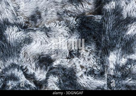 Gray and white faux fur texture background with soft fluffy shaggy wool material surface pattern close up showing warm cozy fashion fabric detail and Stock Photo