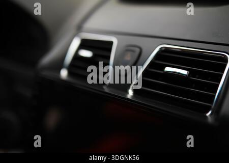 The process of choosing climate control in the car. Man regulating temperature on car air condition. Modern car interior Stock Photo