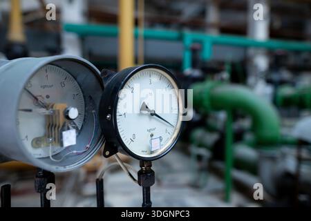 Pressure gauges at the pump station in the water preparation section of a heat exchanger circuit. The gauges are mounted on a control panel, monitorin Stock Photo