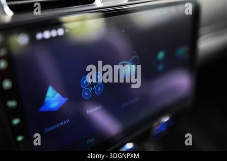 The process of choosing climate control in the car. Man regulating temperature on car air condition. Modern car interior Stock Photo