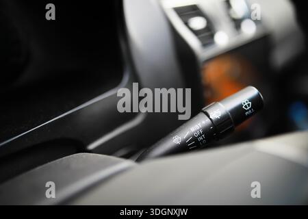 The process of choosing climate control in the car. Man regulating temperature on car air condition. Modern car interior Stock Photo