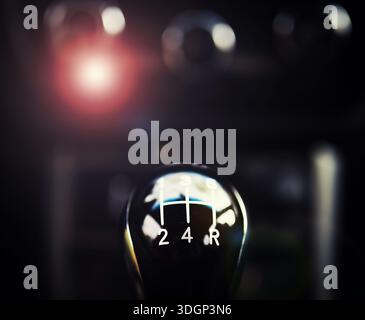 Close up view of a gear lever shift. Manual gearbox. Car interior details. Car transmission. Soft lighting. Stock Photo