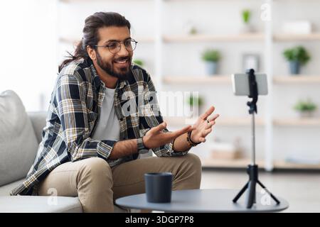 handsome arab guy with glasses blogger streaming from home Stock Photo