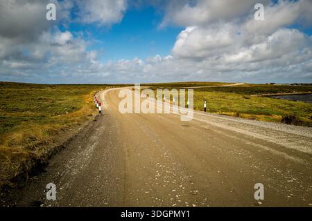 This scenic route curves through rolling hills and open fields, inviting exploration and adventure on a journey into the distance Stock Photo